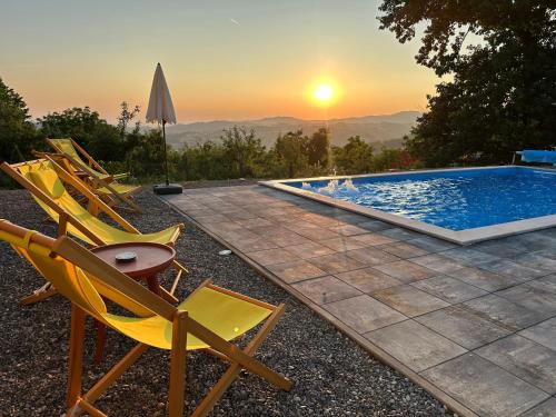 a group of chairs sitting next to a swimming pool at Villa Dalia in Gračanica