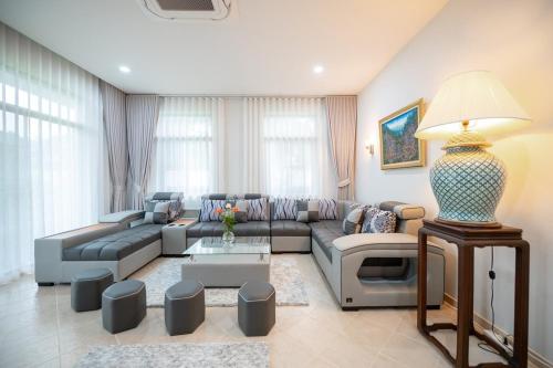 a living room with a couch and a table at Sriwaree Pool Villa Khao Lak - 8 meters pool - 3 bedroom - 2 bath in Khao Lak