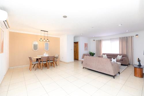 a living room with a couch and a table at POLO HEIGHTS-Sky Suites in Accra