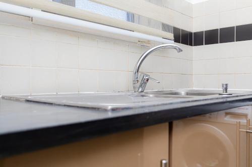 a kitchen counter with a sink in a kitchen at POLO HEIGHTS-Sky Suites in Accra