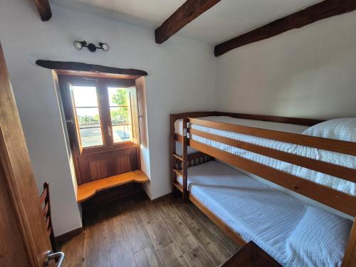 a bedroom with two bunk beds and a window at Casa Rural Lomo Lugo in Isora