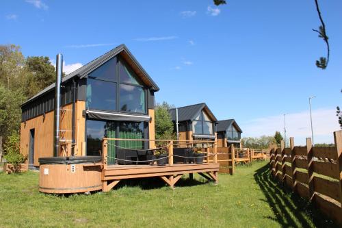 a row of cottages on display in a field at Domki Fajnie.Tu in Łączna