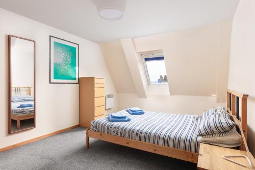 a bedroom with a bed and a mirror at Starfish Accommodation in Whitby
