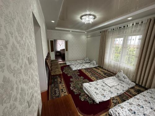 Ένα ή περισσότερα κρεβάτια σε δωμάτιο στο Guest House Akzhol