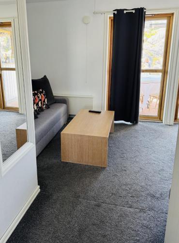 a living room with a couch and a coffee table at Hotell Bistro Port Sud in Skärhamn