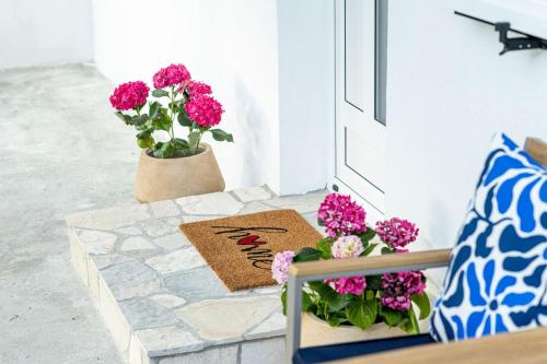 a porch with flowers and a welcome mat at Nadalina in Igalo