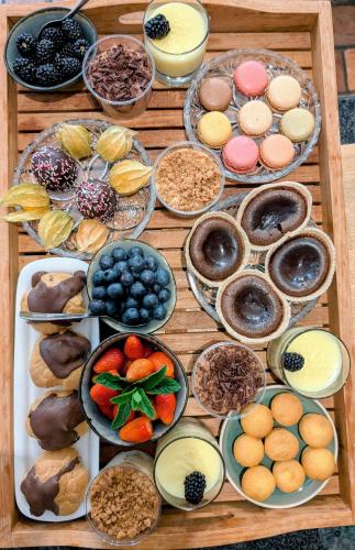 a wooden table topped with bowls of different types of food at Rêveries in Roeselare