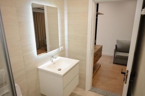 a bathroom with a white sink and a mirror at Vila Venezia in Shëngjin