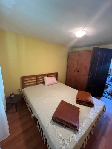 a bedroom with a bed with two towels on it at Vikendica Mali Pozarevac 