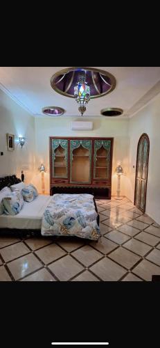 a bedroom with a large bed and a chandelier at Eden Suites 