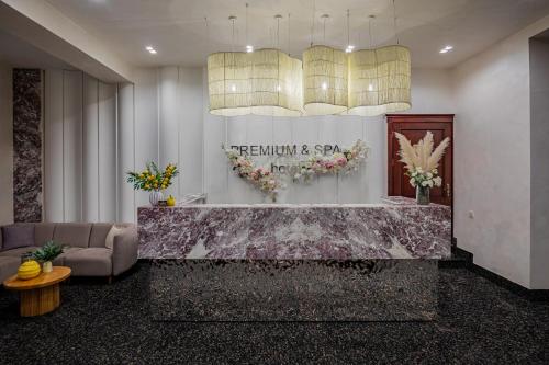 a lobby with a reception desk and a couch at Premium hotel & SPA in Bukovel