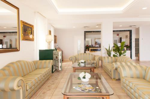 a living room with couches and a table at Baia D'Argento in Porto Santo Stefano