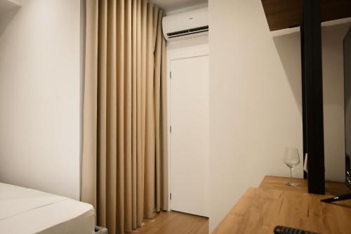 a bedroom with a bed and a curtain at Vila Venezia in Shëngjin