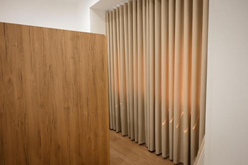 a hallway with a row of vertical blinds at Vila Venezia in Shëngjin