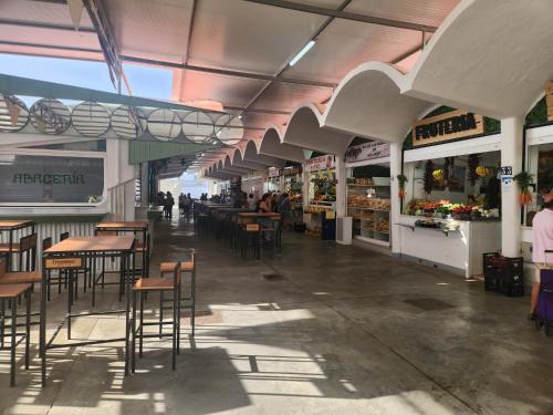 a restaurant with tables and chairs in a building at ELEVENLIGHTS-COSTABALLENA Garden View in Costa Ballena
