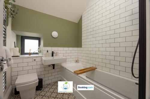 Un baño con bañera, lavabo e inodoro. en 2 Bedroom Apartment By Green Haven Escapes Short Lets & Serviced Accommodation In Leeds with Free WiFi & Parking, en Farnley