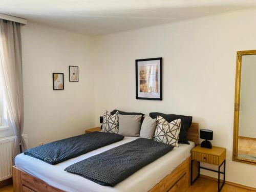 a bedroom with a large bed with a mirror at Apartment beim Schloss Ort mit Balkon und Parkplatz in Gmunden
