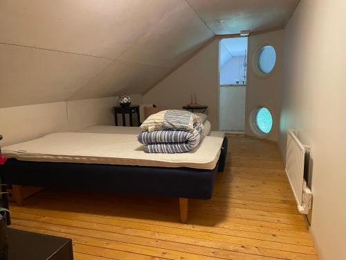 a large bed in a room with two windows at Upscale Hideaway in Converted Barn in Vireda