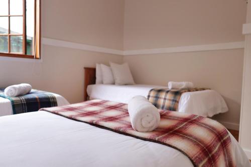 a bedroom with two beds with towels on them at Highlands Lodge Mountain Retreat in George