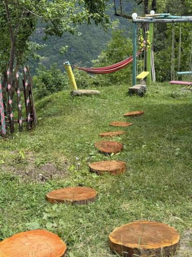 a group of stepping stones in the grass at Happy days house in Shuakhevi