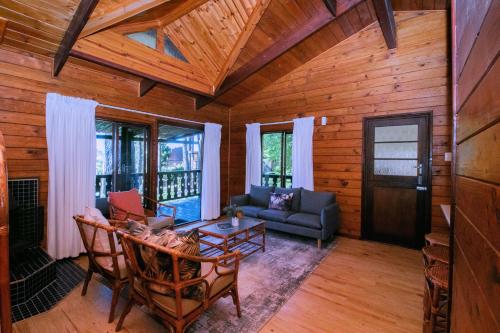 a living room with a couch and a table at Highlands Lodge Mountain Retreat in George