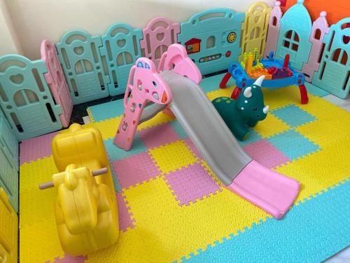a toy playset with a slide and a toy town at Front One Hotel Purwodadi in Purwodadi