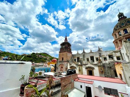 an old building next to a body of water at Charming Cocoon with Balcony - Historic downtown in Guanajuato