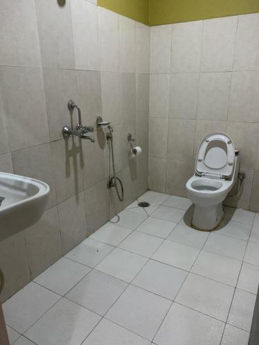 a bathroom with a toilet and a sink at Hotel August International in Pokhara