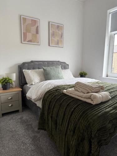 a bedroom with a bed with two towels on it at ResiLets - Stanley House - Large, Modern 3 Bed - NEW! in Blythe
