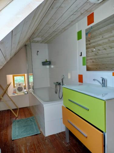 une salle de bain avec un lavabo et une baignoire dans l'établissement moulin dans les bois - Finistère, à Pont-Croix