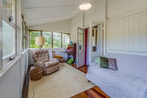 a living room with a couch and a chair at Tarran in Mount Tamborine