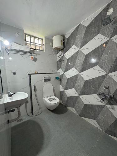 a bathroom with a toilet and a sink at NMS Grand View in Pondicherry