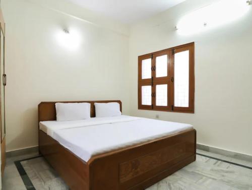 a bedroom with a large bed with a window at HOTEL SHREE BHAMESHWAR Near Mansa Devi Temple and Chandi Devi Temple# Ganga River - Fully Air conditioned Rooms - Best Budget Hotel in Haridwār