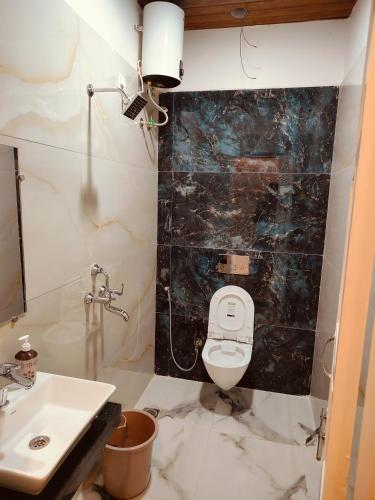 a bathroom with a toilet and a sink at The Rajshahi Vilas in Udaipur