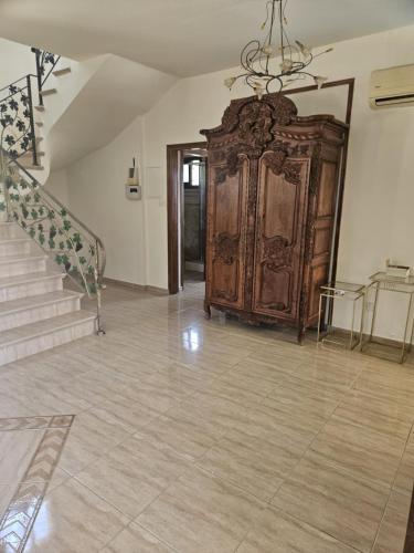 a room with a large wooden cabinet and stairs at Kallithea Villa in Kato Yialia
