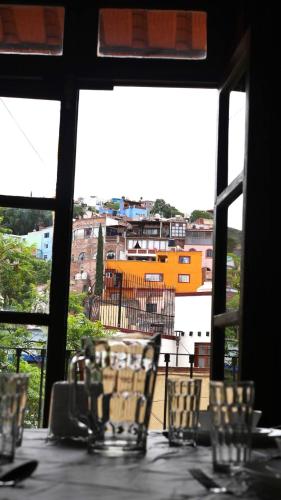 a table with chairs and a view of a building at Charming Cocoon with Balcony - Historic downtown in Guanajuato