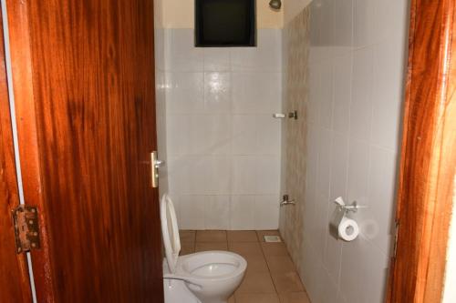 a bathroom with a toilet and a television in it at Anuka Luxury in Mombasa