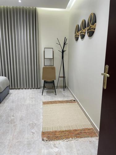 a hallway with a room with a bed and a chair at شقق مسك الفندقية MISK Apartments in Riyadh Al Khabra