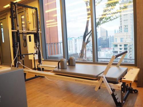 a gym with a bench in front of a window at Circle Sukhumvit31 Bangkok #2BR #5ppl in Bangkok