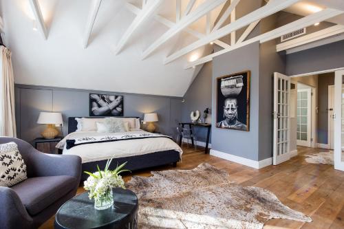 a bedroom with a king sized bed and a couch at 14 on Klein Constantia in Cape Town