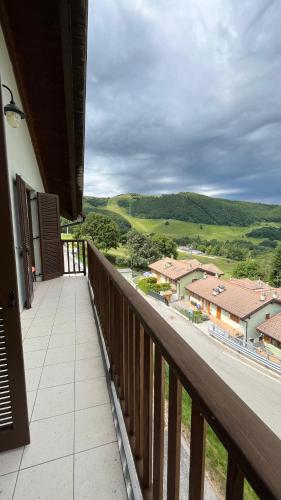a balcony with a view of the countryside at Hotel Residence Bellavista - Camping Polsa in Brentonico