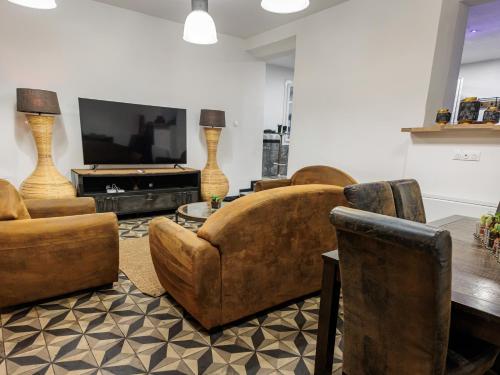 a living room with couches and a flat screen tv at Loft SSL insolite!!! in Gignac-la-Nerthe