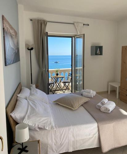 a bedroom with a bed with a view of the ocean at Aquamaris in Giovinazzo