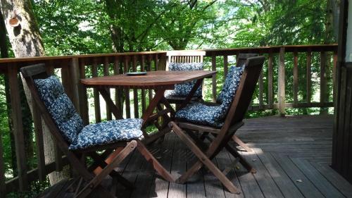 a wooden table and two chairs on a deck at Ferienhaus Gädda in Vöhl