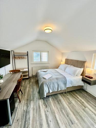 a bedroom with a bed and a desk and a computer at Saltburn Sea Front Penthouse South in Saltburn-by-the-Sea