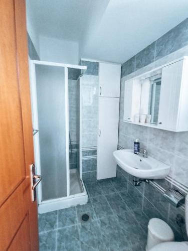 a bathroom with a shower and a sink at Haraki Aqua Blue in Haraki