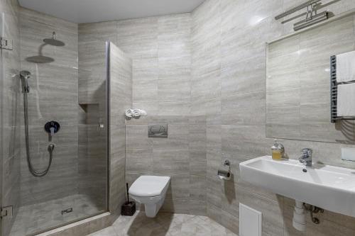 a bathroom with a shower and a toilet and a sink at Premium hotel & SPA in Bukovel