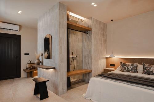 a bedroom with a bed and a wooden wall at Emery Hotel in Naxos Chora