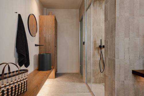 a bathroom with a shower and a walk in shower at Emery Hotel in Naxos Chora