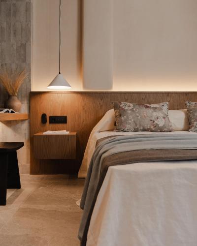 a bedroom with a bed and a pendant light at Emery Hotel in Naxos Chora